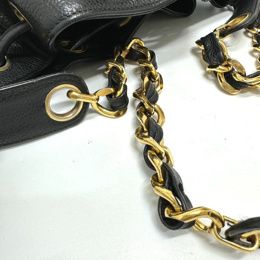 Black leather handbag with gold chain strap on a white background