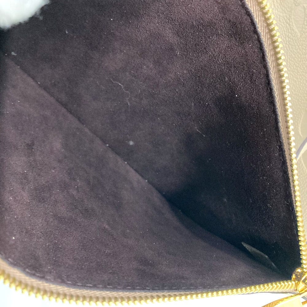 Close-up of a dark purple fabric interior with gold zipper