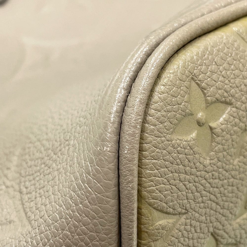 Close-up of a textured beige leather surface with a floral embossment.