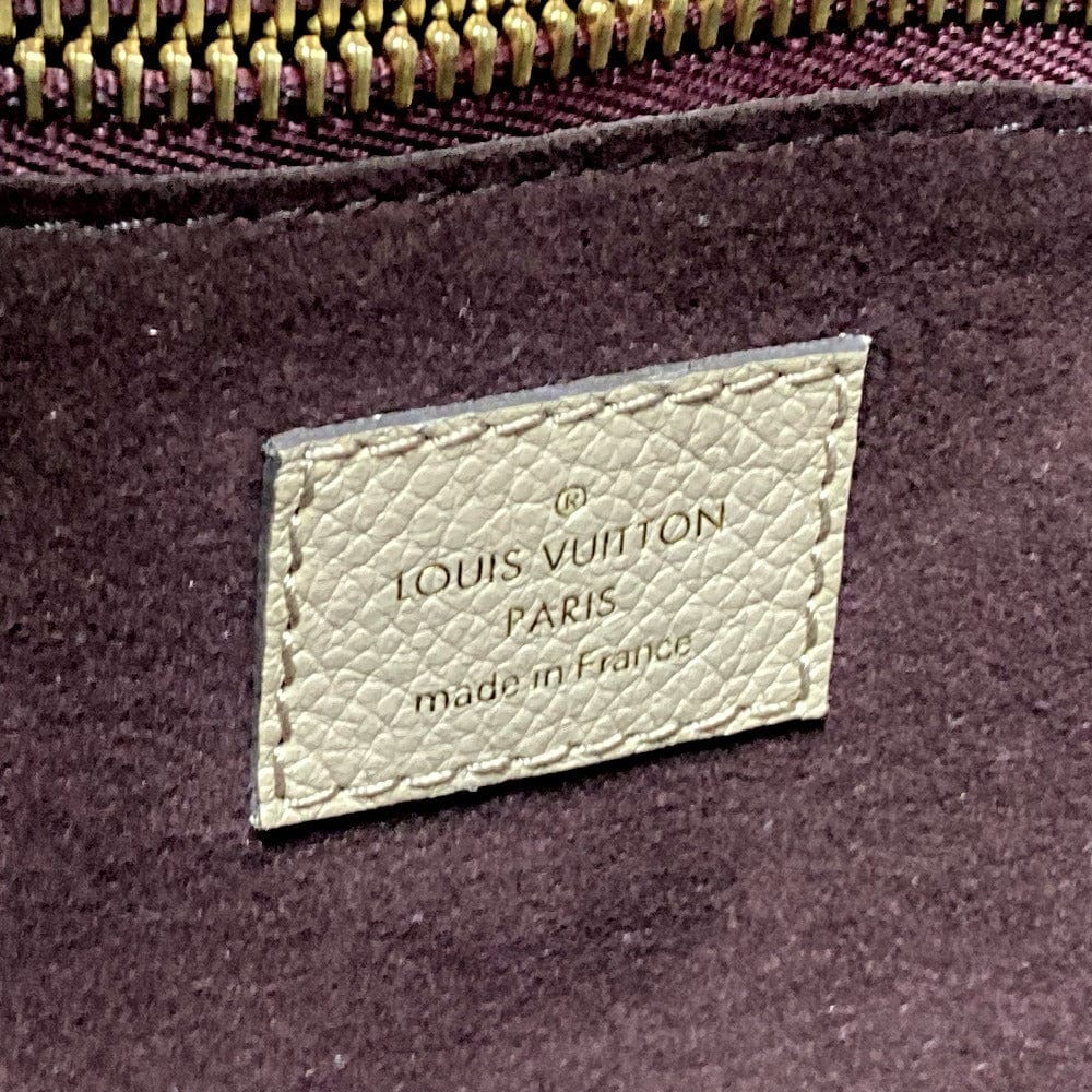 Louis Vuitton label on a purple fabric background