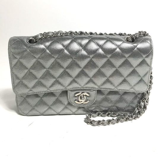 Silver quilted handbag with chain strap on a white background