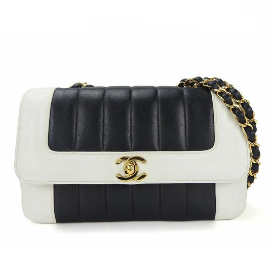 Black and white quilted handbag with gold chain strap on a white background