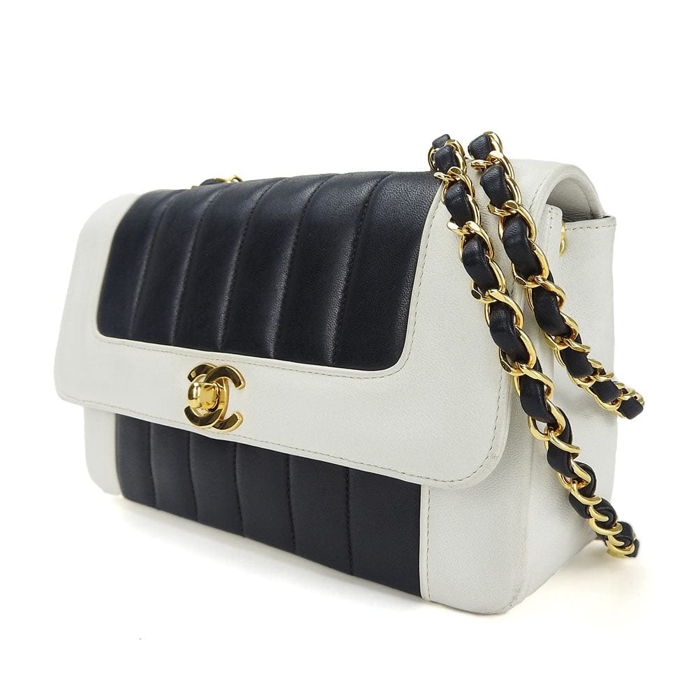 Black and white quilted handbag with gold chain on a white background