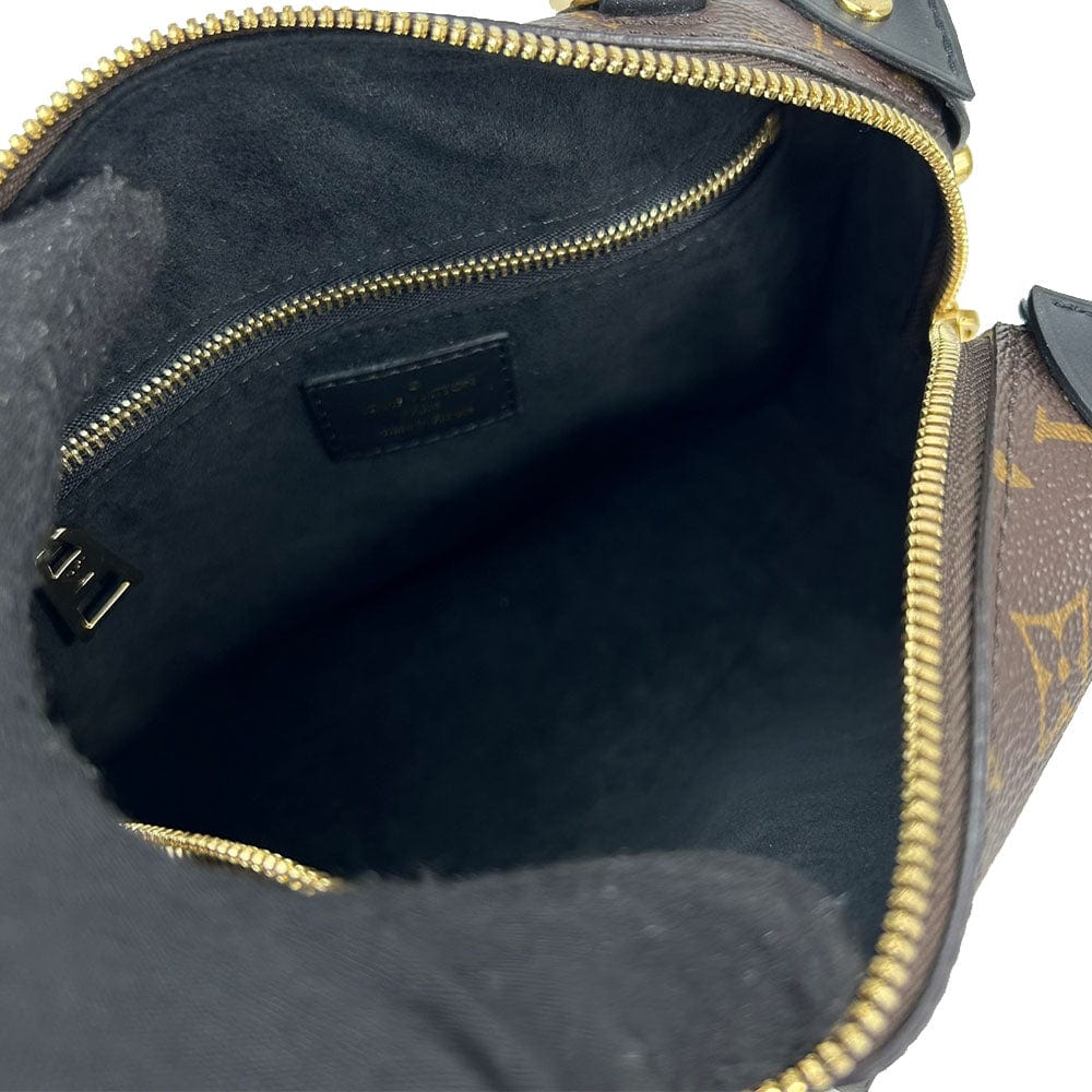 Close-up of a Louis Vuitton handbag with monogram pattern and gold zipper.