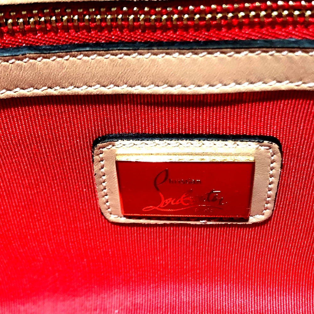 Red handbag with a gold and red logo tag, featuring the brand name.