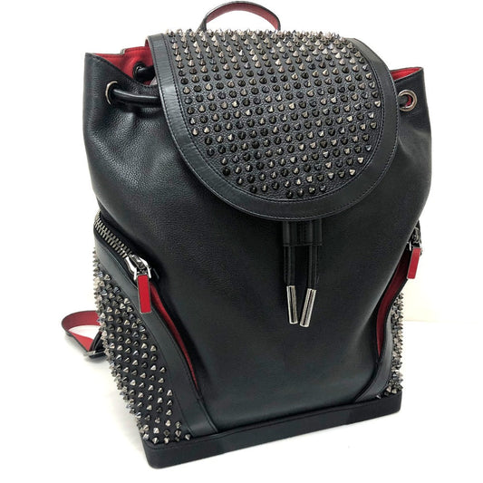 Black backpack with studded details on a white background