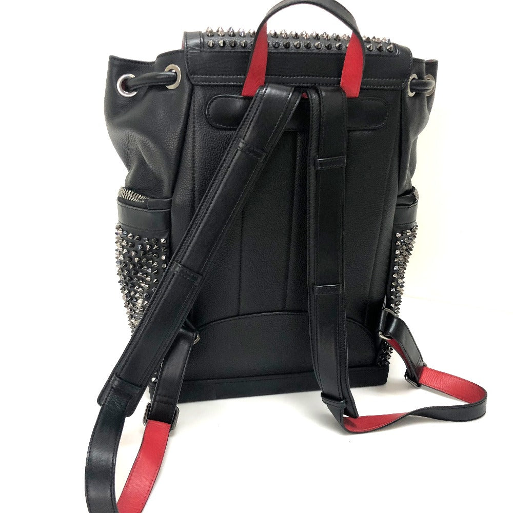 Black backpack with red accents and studded details on a white background