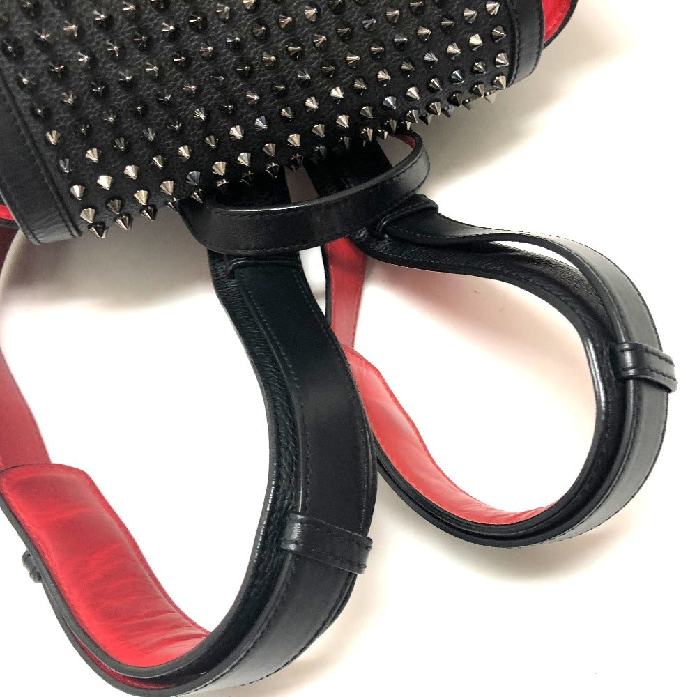 Close-up of a black and red leather product with studded detail on a white background