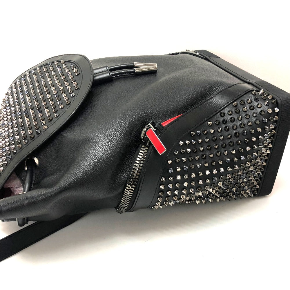 Black studded handbag with a red zipper pull on a white background