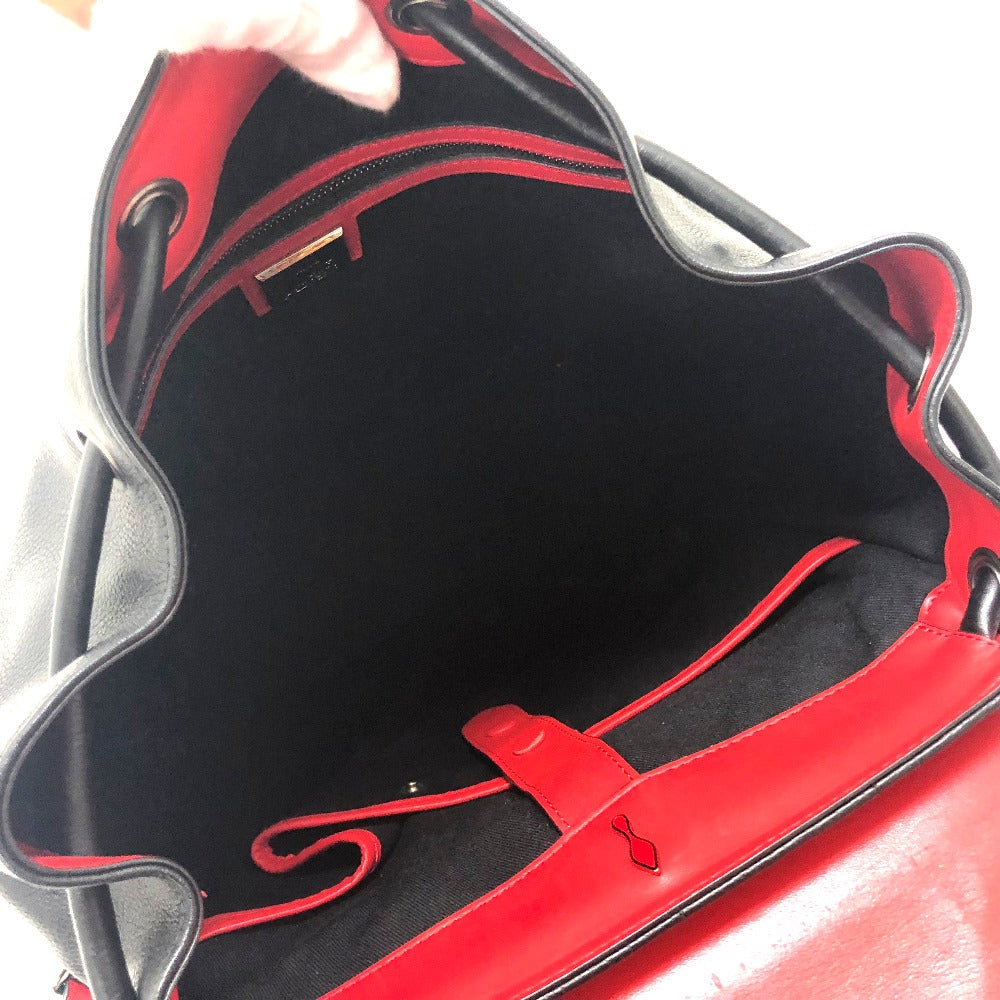 Close-up of a red and black handbag with a visible brand logo.