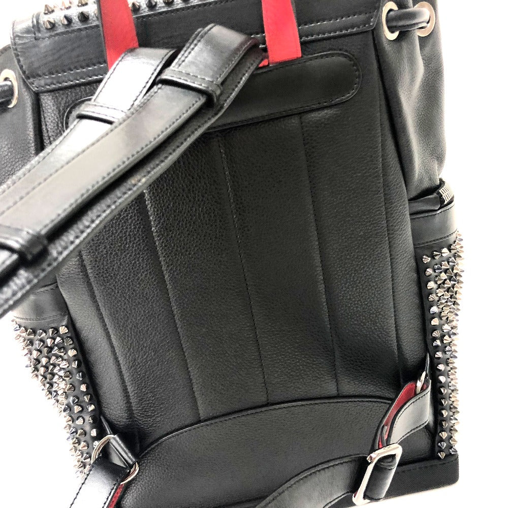 Black leather backpack with studded details and red straps on a white background
