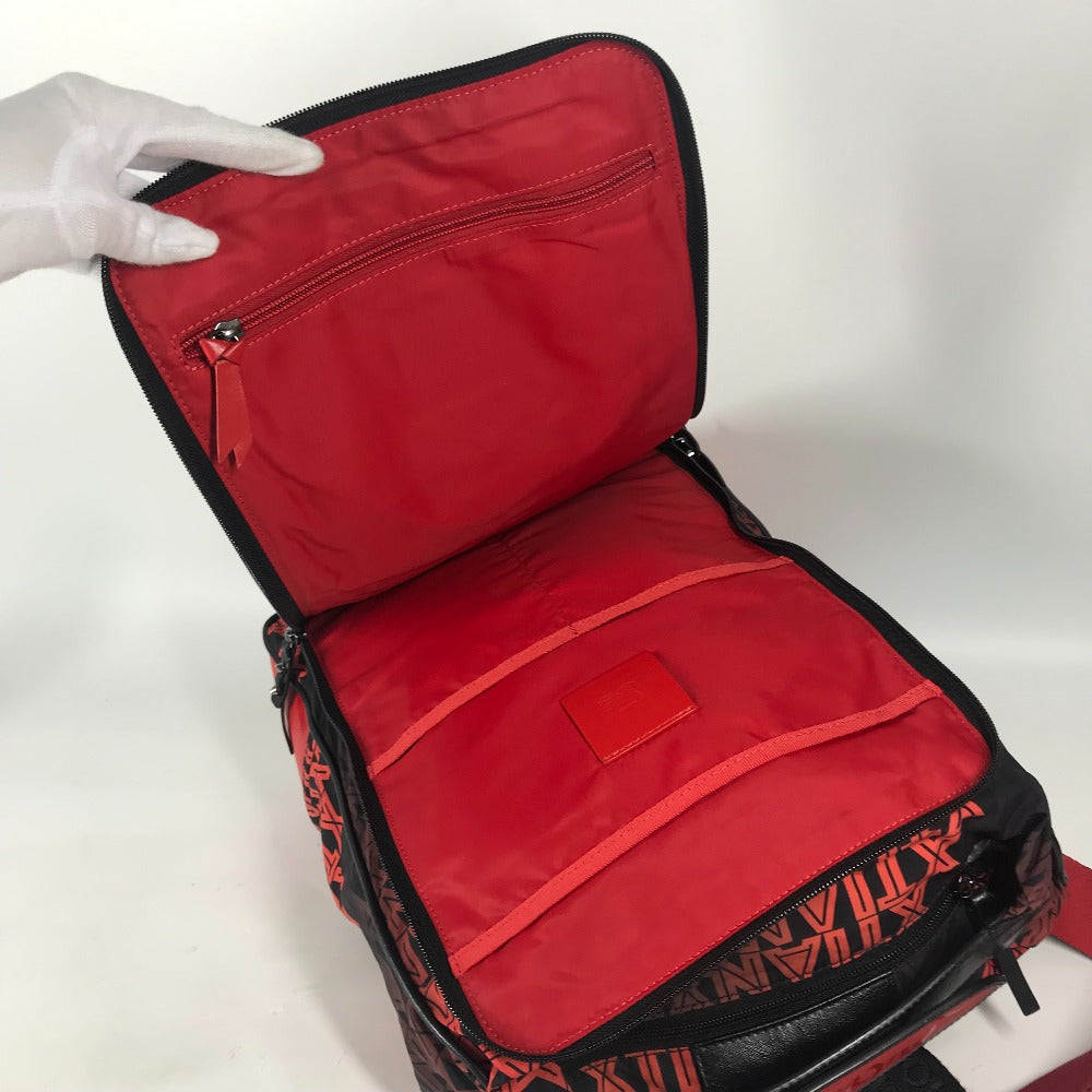 Red and black backpack with a hand opening it on a white background