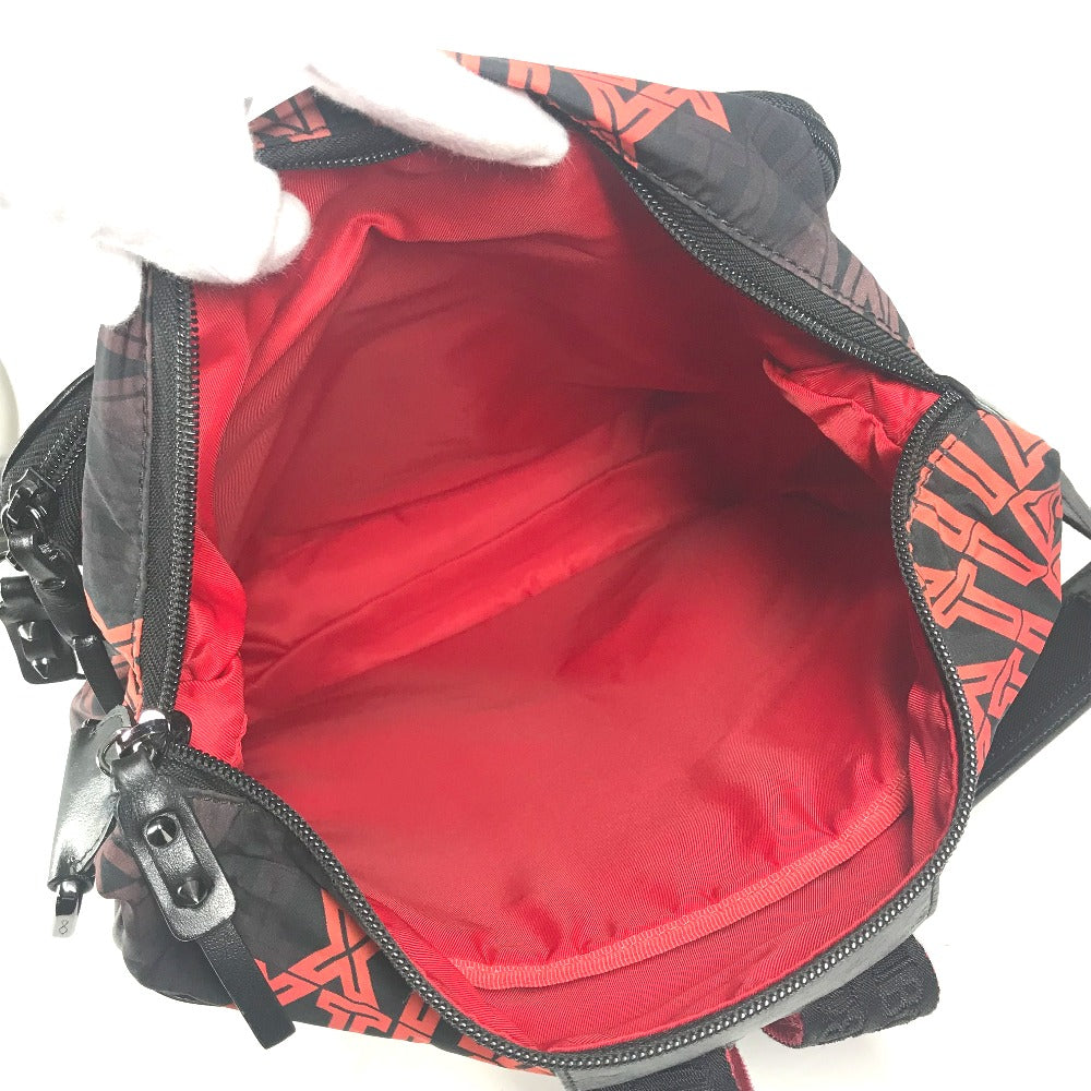 Open bag with red interior and black and orange patterned exterior.