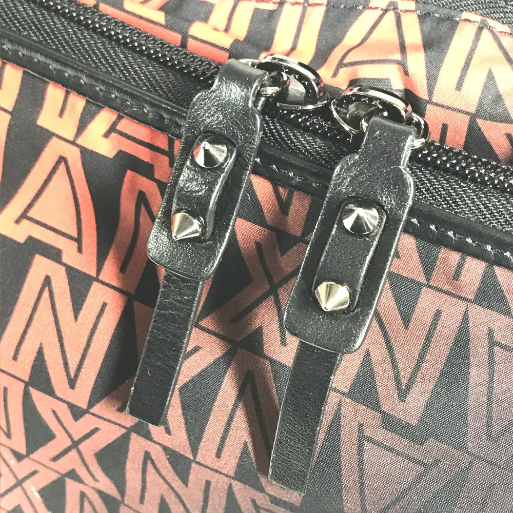 Close-up of a black zipper with metal pull on a patterned background