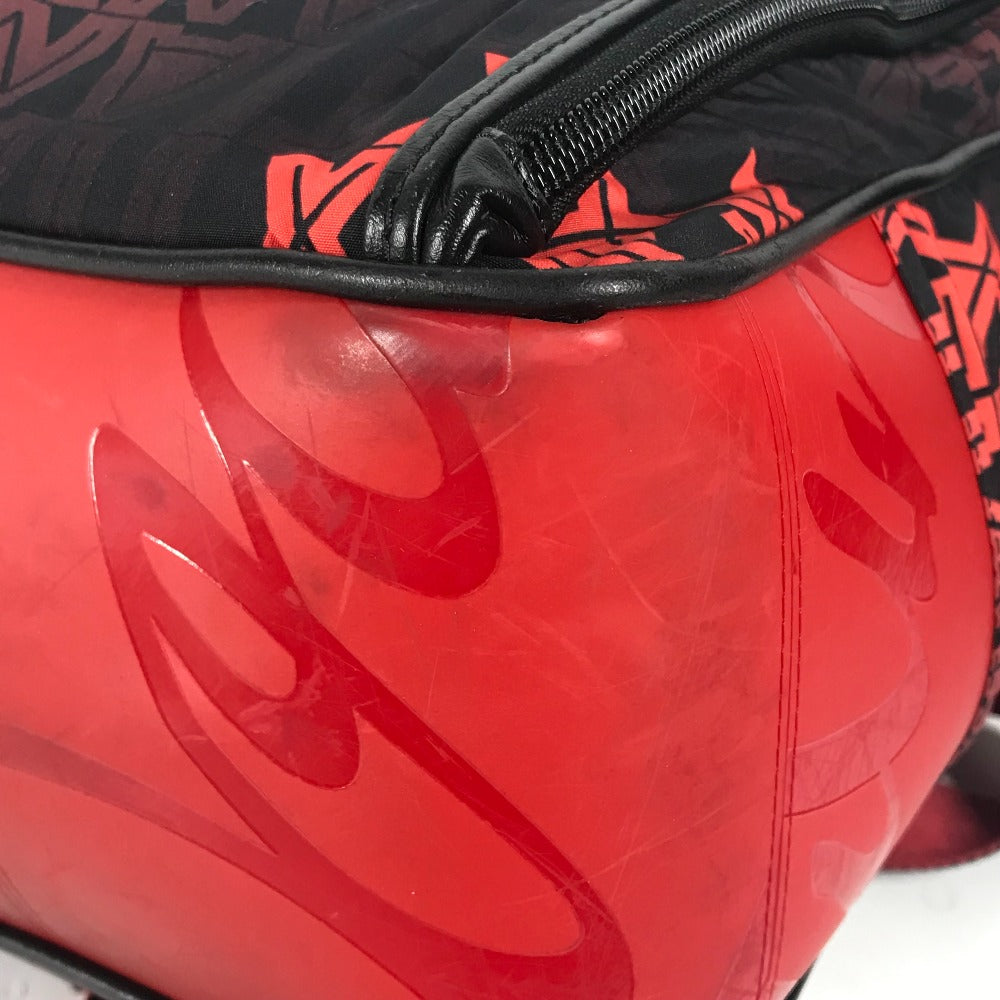 Close-up of a red and black bag with a prominent brand logo.