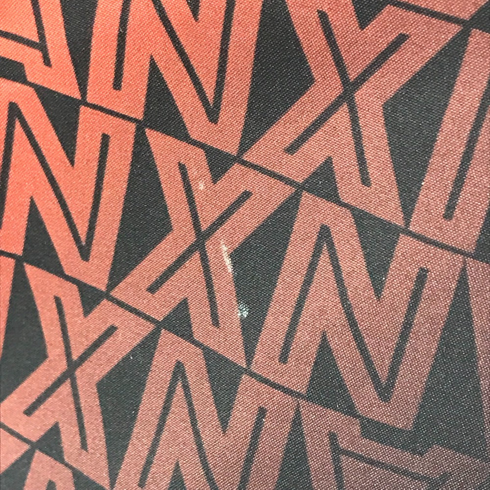 Geometric pattern with red and black shapes on a textured surface