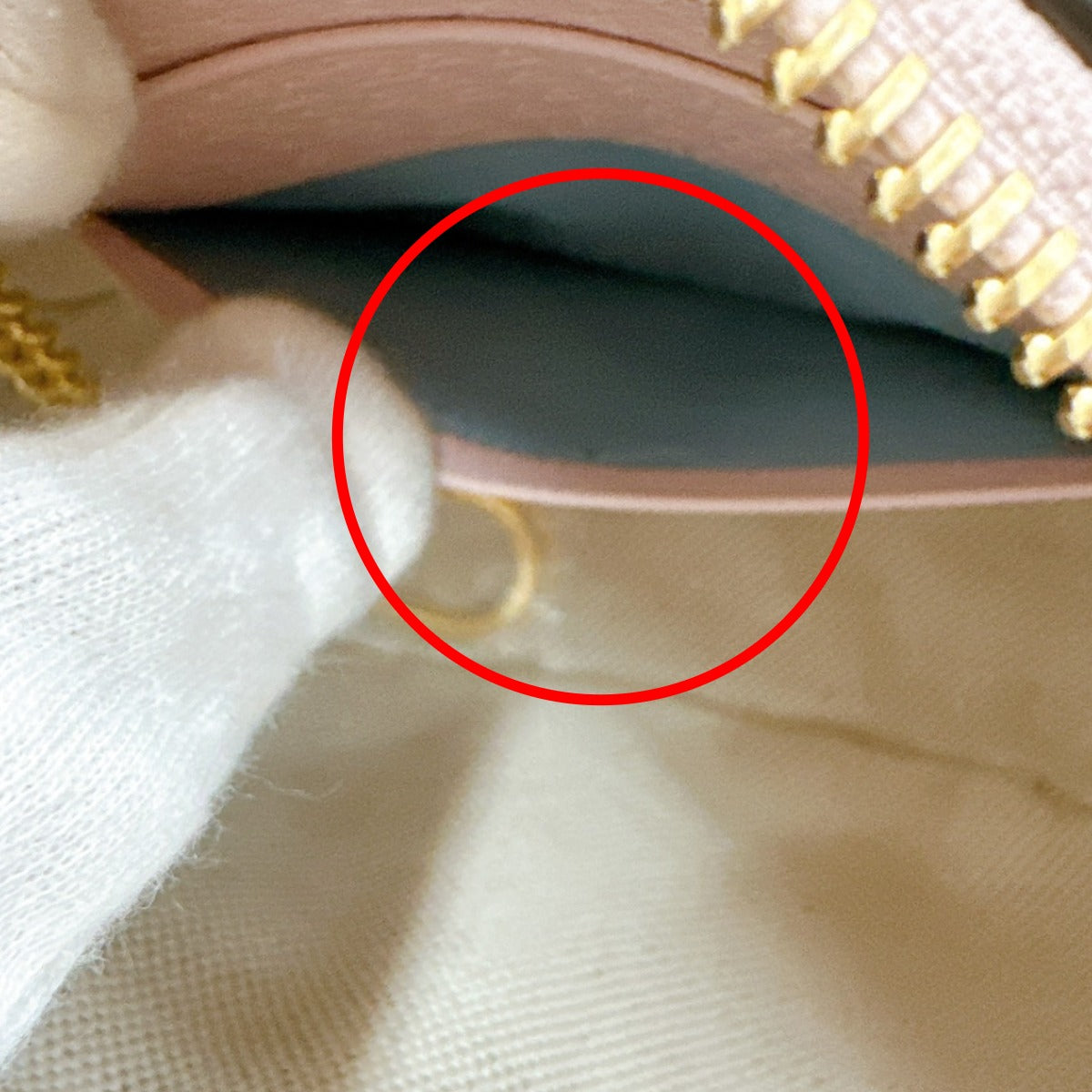 Close-up of a fabric texture with a red circle highlighting a thread or defect.