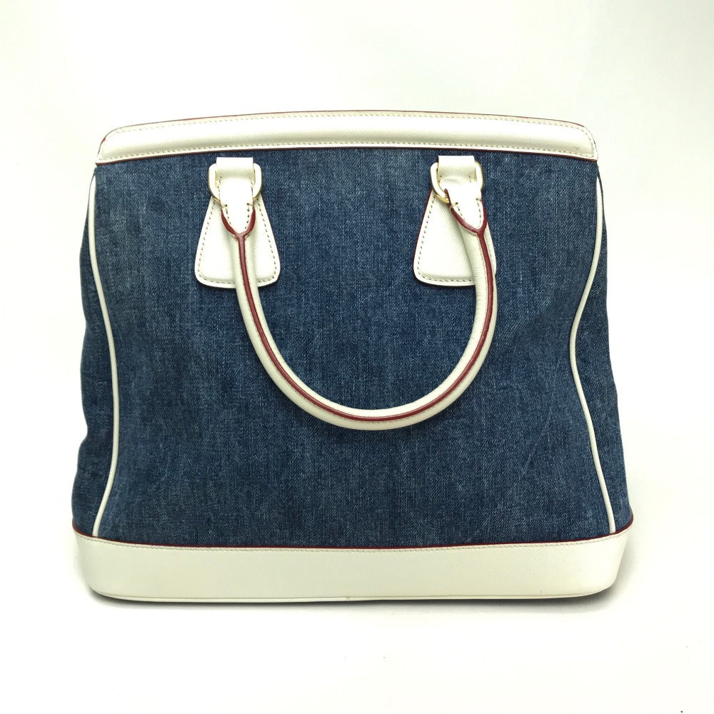 Blue denim bag with white handles and trim on a white background