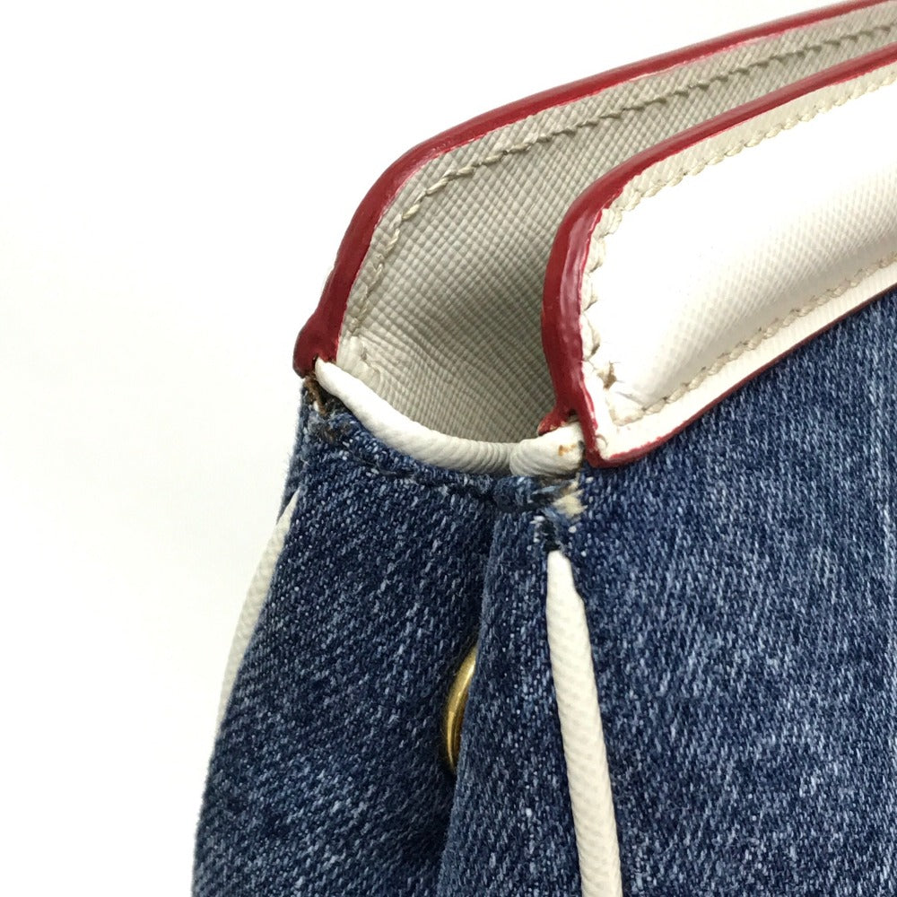 Close-up of a blue denim product with red and white interior lining on a white background