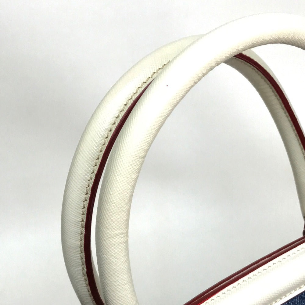 Close-up of a white steering wheel with red stitching on a light gray background