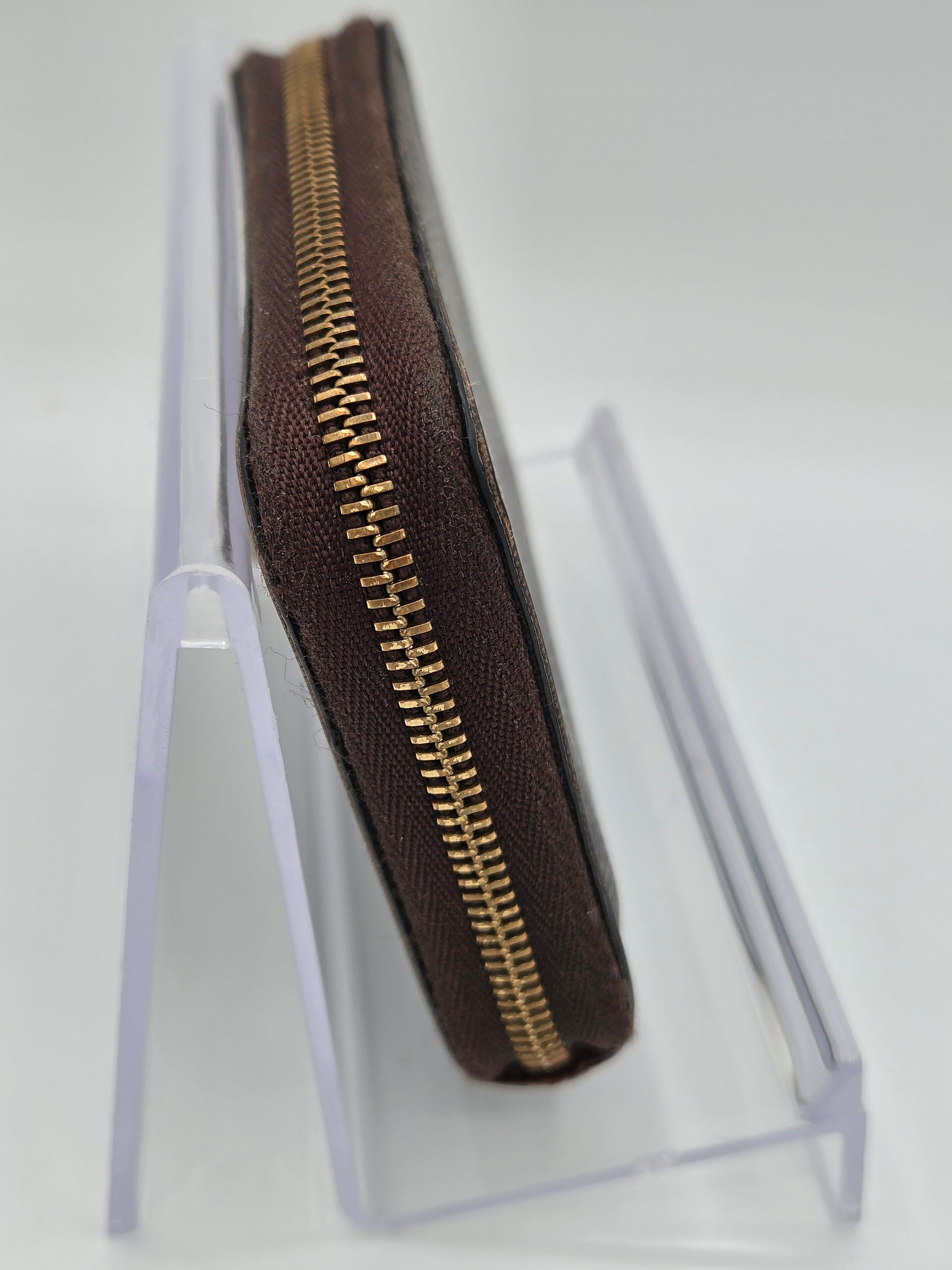 Brown zipper pouch with gold zipper on a white background