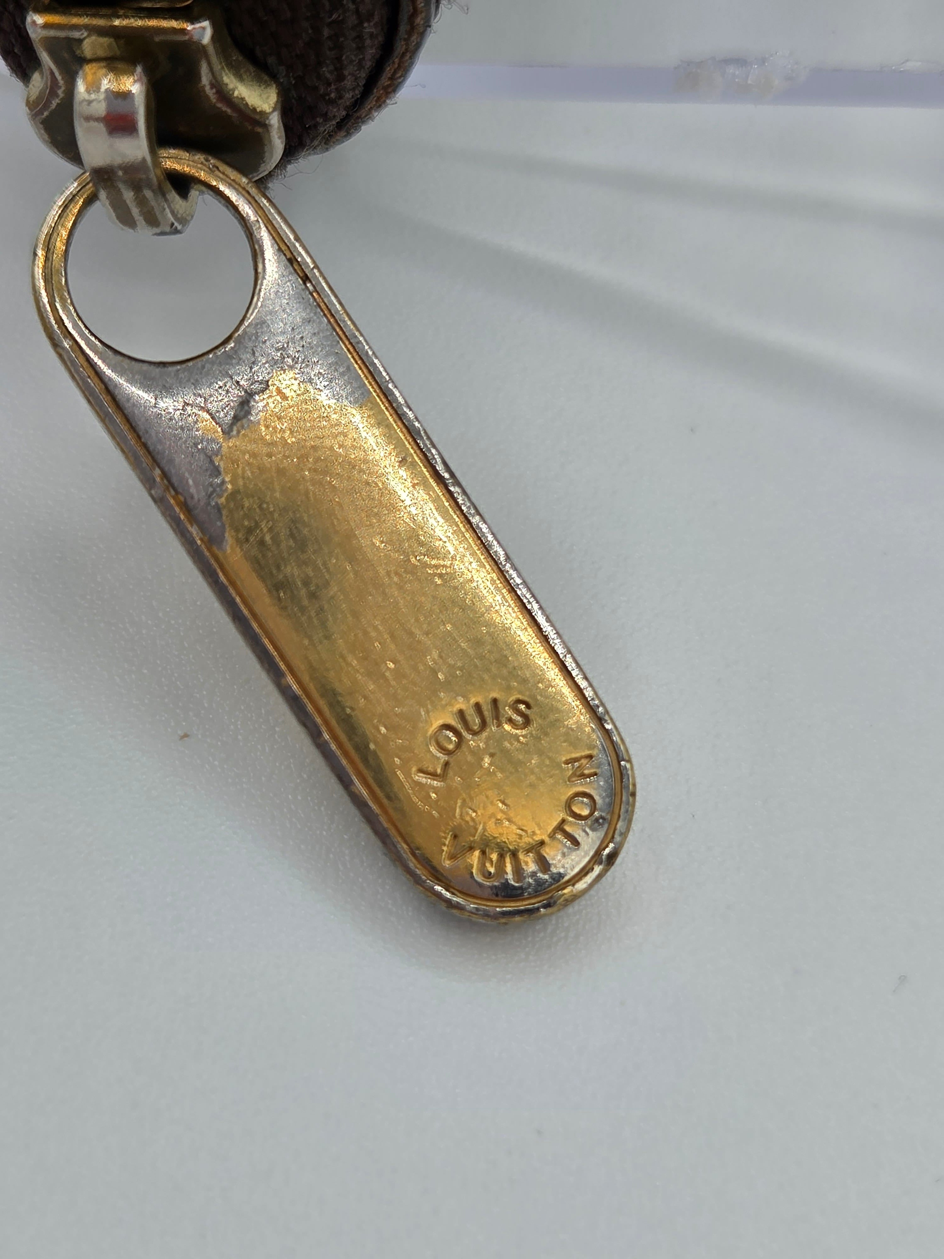 Close-up of a gold and silver keychain clasp on a white background