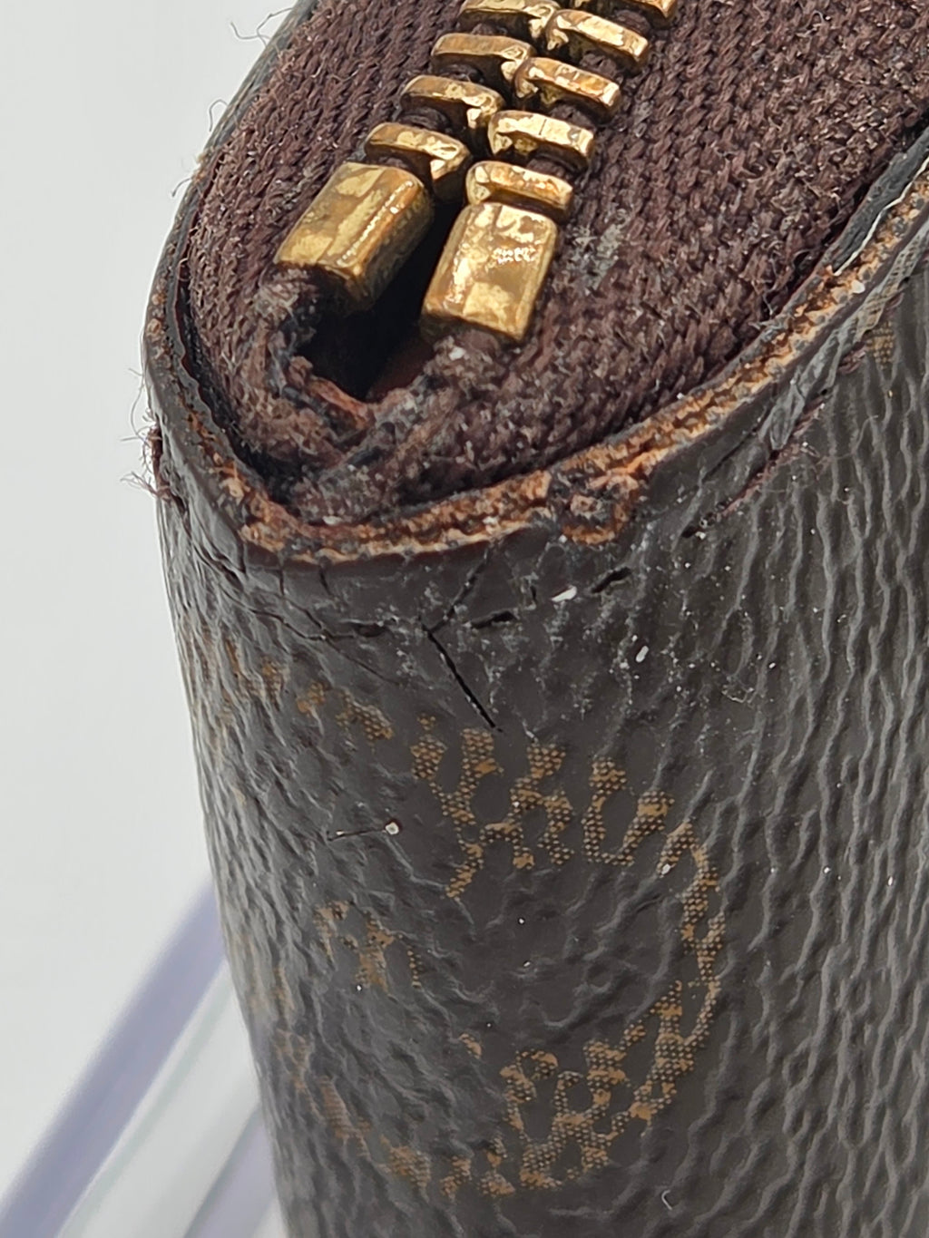 Close-up of a textured brown leather bag with gold zipper