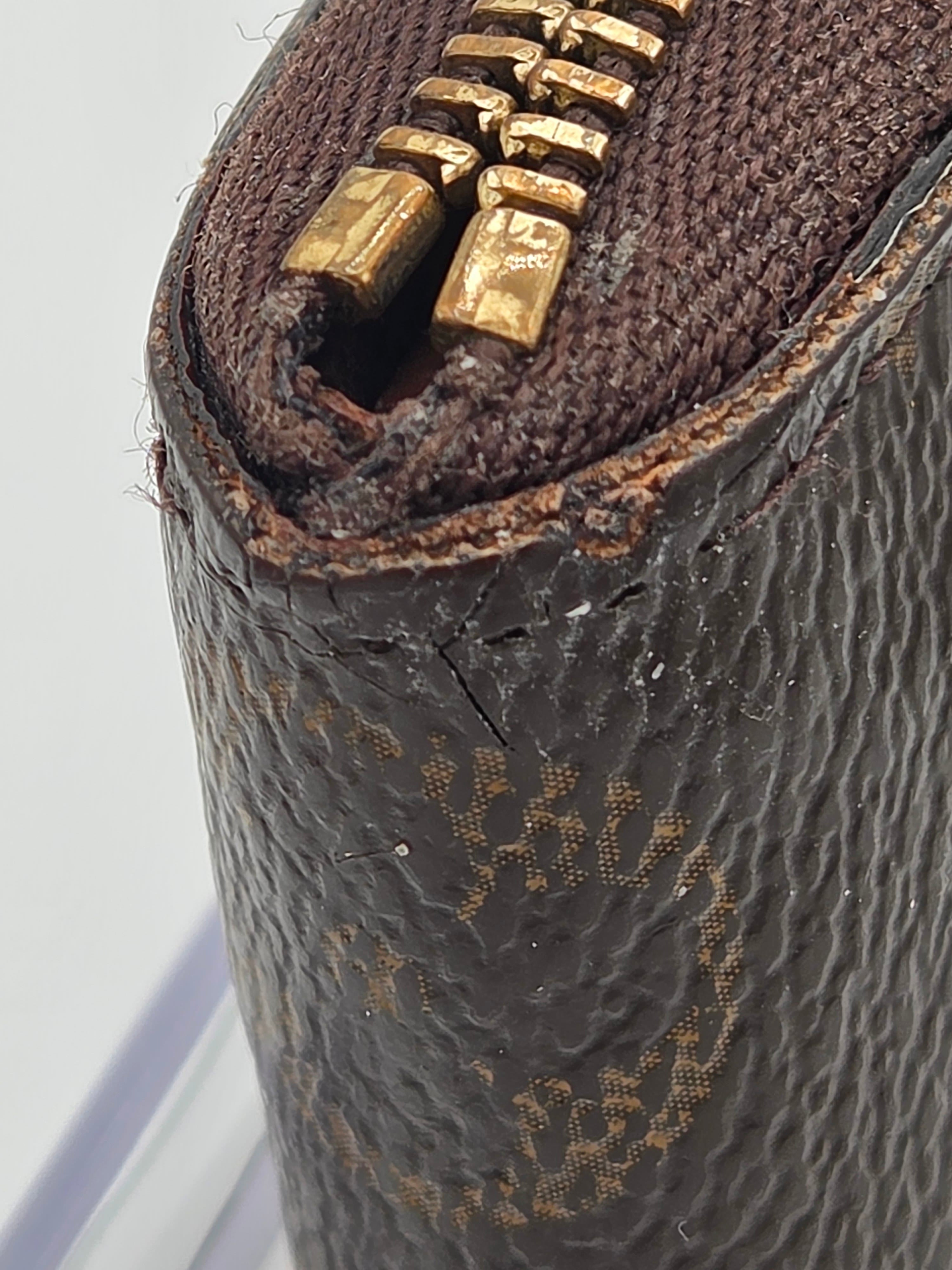 Close-up of a textured brown leather bag with gold zipper