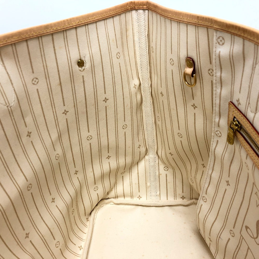 Close-up of a beige handbag with a patterned interior.
