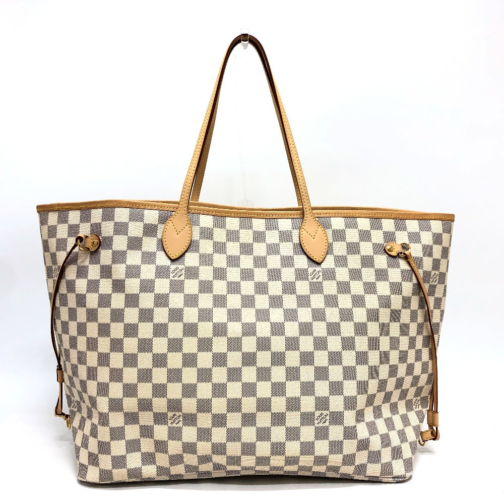 Checkered handbag with brown handles and straps on a white background