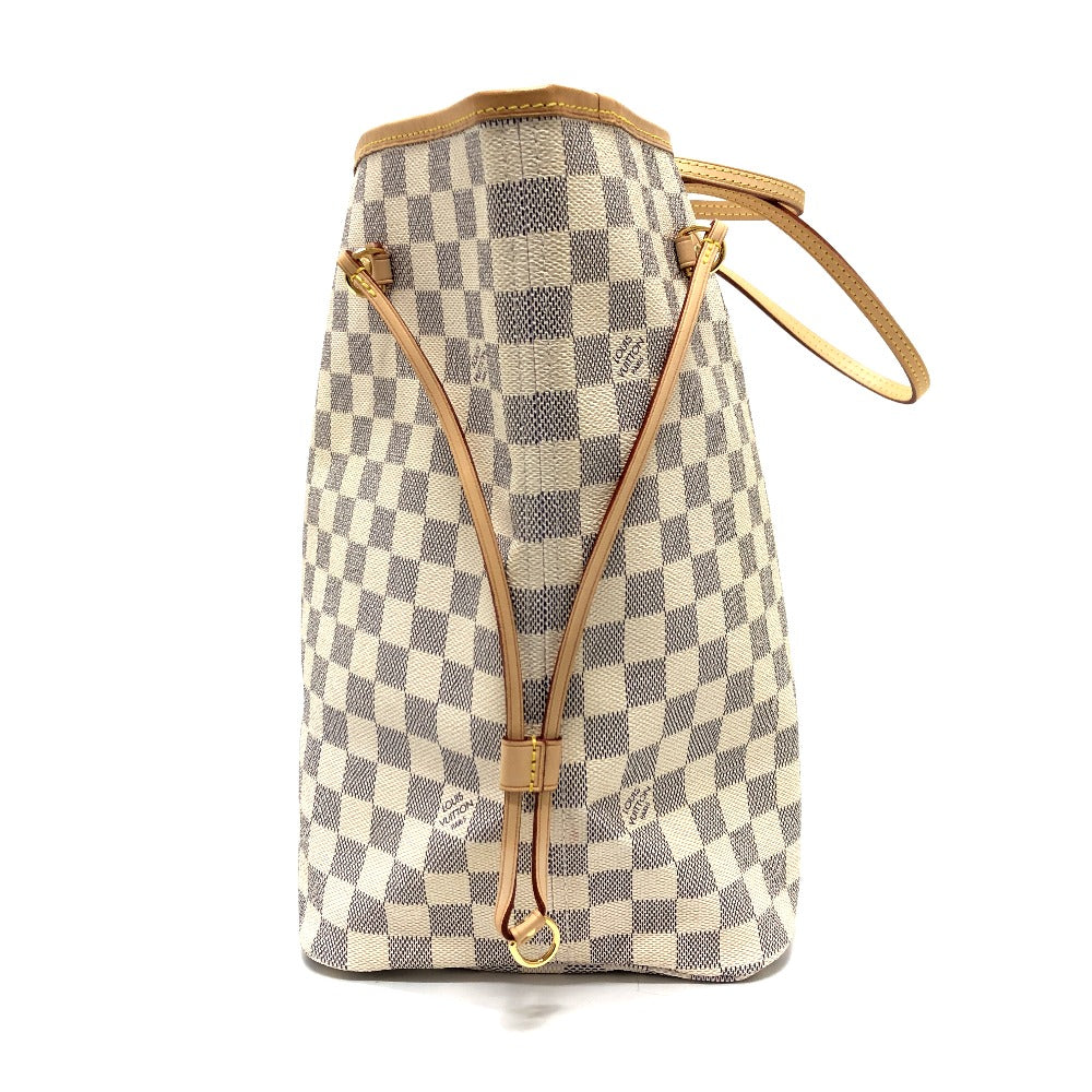 Checkered handbag with gold accents on a white background