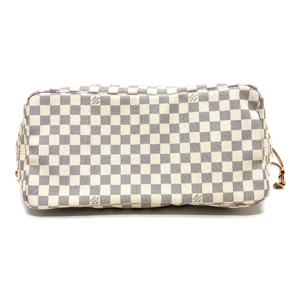 Checkered handbag with gold accents on a white background