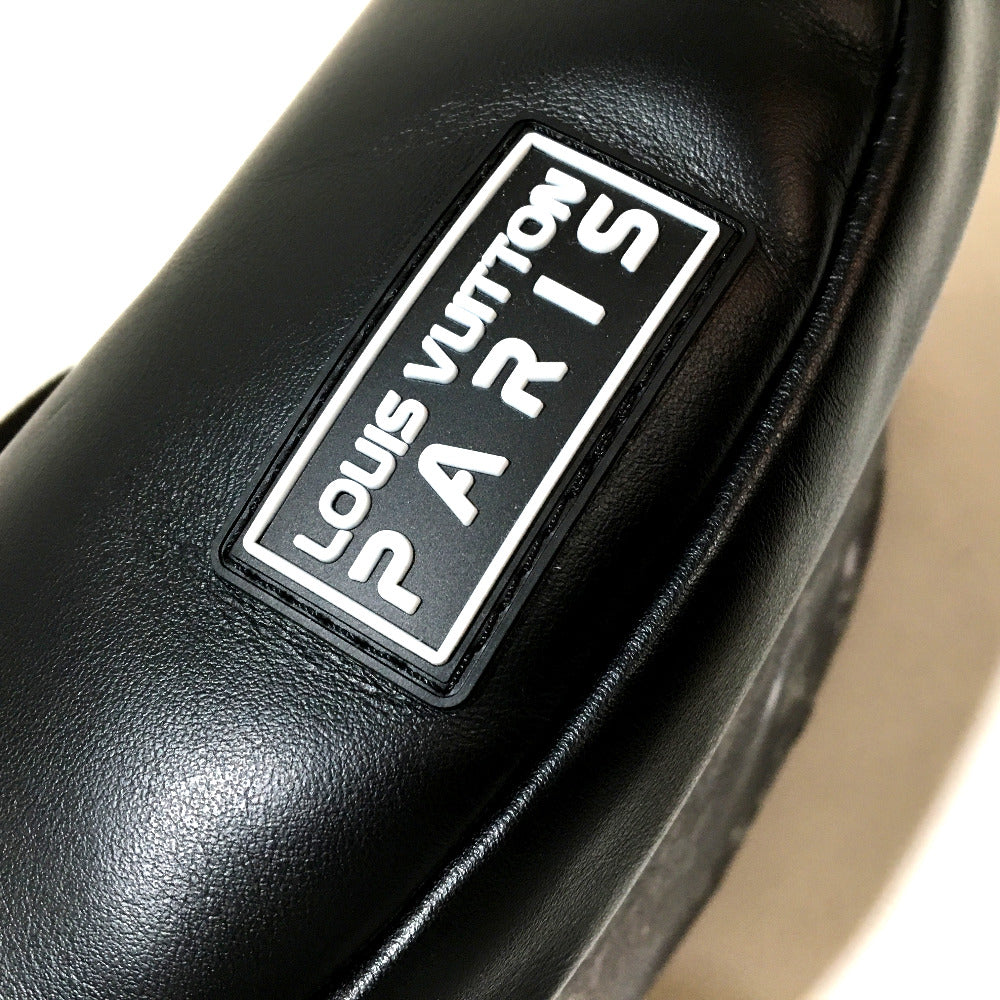 Close-up of a black leather product with a Louis Vuitton Paris label.
