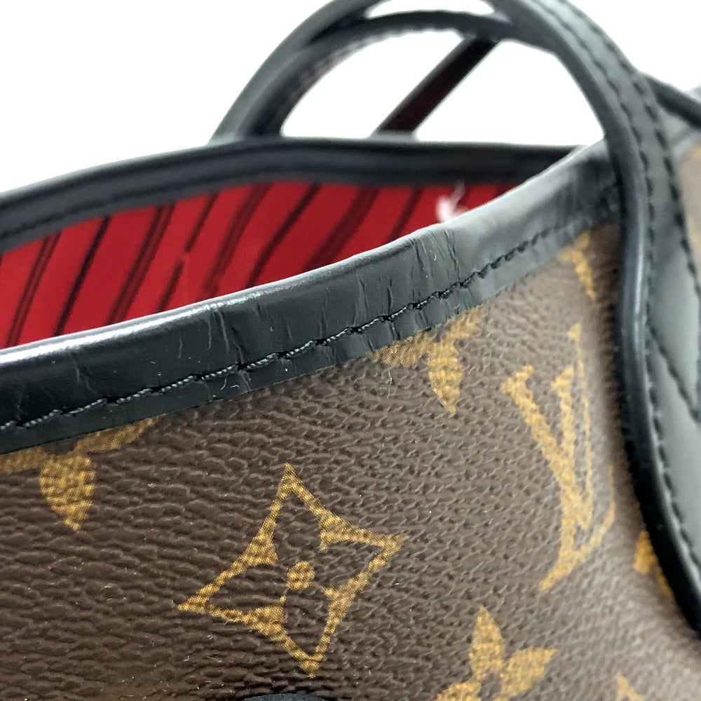 Close-up of a brown leather handbag with gold monogram pattern and black interior.