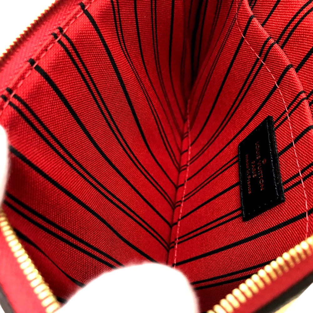 Close-up of a red fabric with black stitching and a brand label.