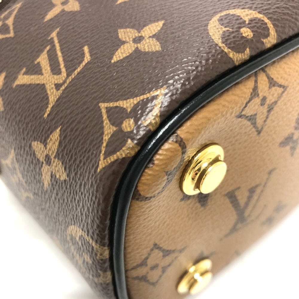 Close-up of a Louis Vuitton handbag with monogram pattern and gold hardware.