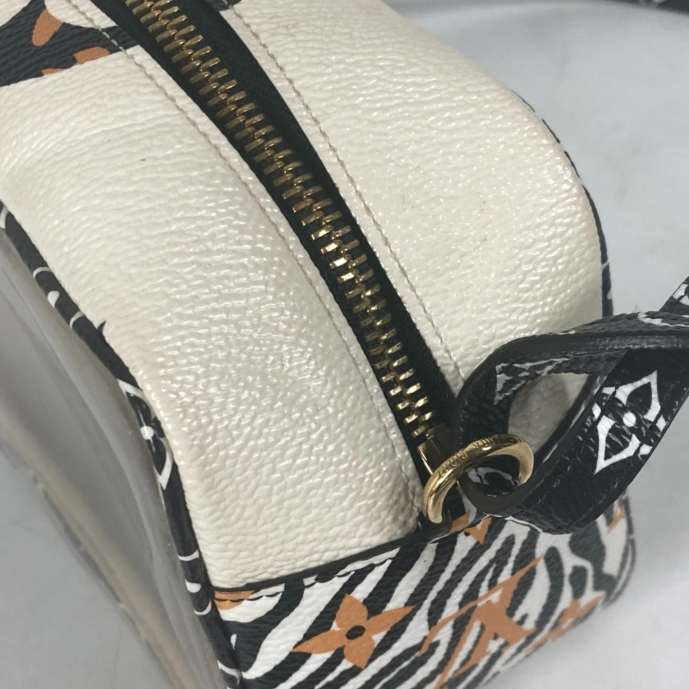 Close-up of a white pouch with a gold zipper and black floral pattern on a white background