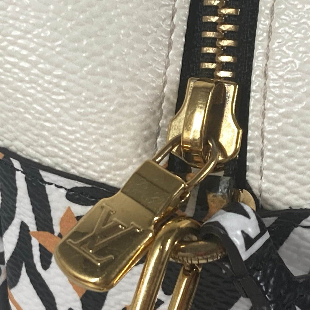 Close-up of a gold zipper on a white textured surface with a brand logo.