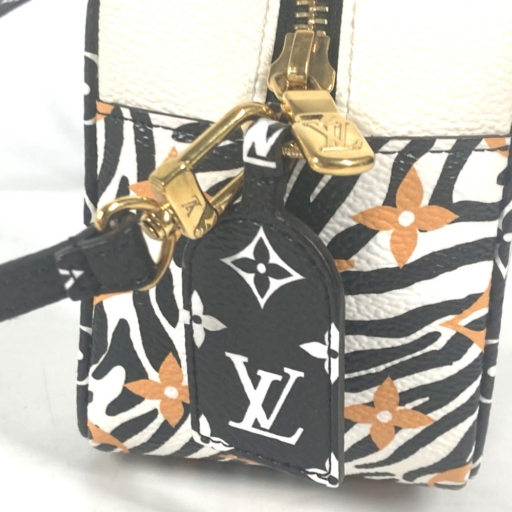 Louis Vuitton keychain attached to a patterned handbag