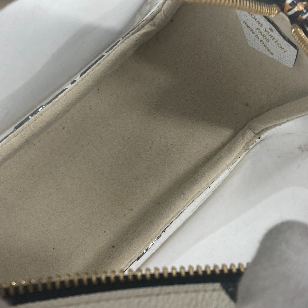 Close-up of a beige wallet with a zipper on a light gray background