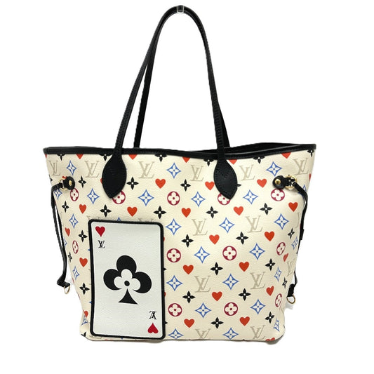 Designer handbag with playing card and monogram pattern on a white background