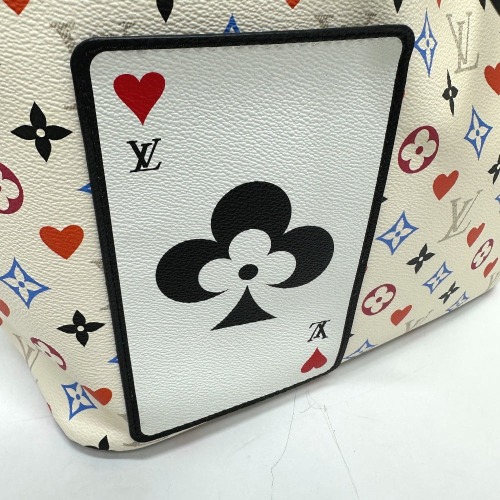 Playing card with black club symbol on a Louis Vuitton patterned surface