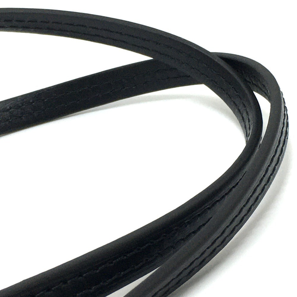 Close-up of a coiled black cable on a white background