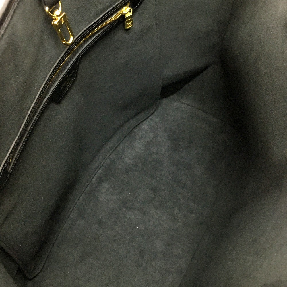 Close-up of a dark gray textured fabric with a gold zipper.