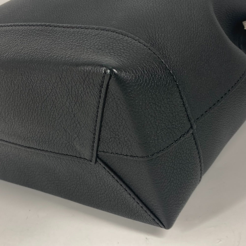 Close-up of a black leather car seat with visible stitching on a white background