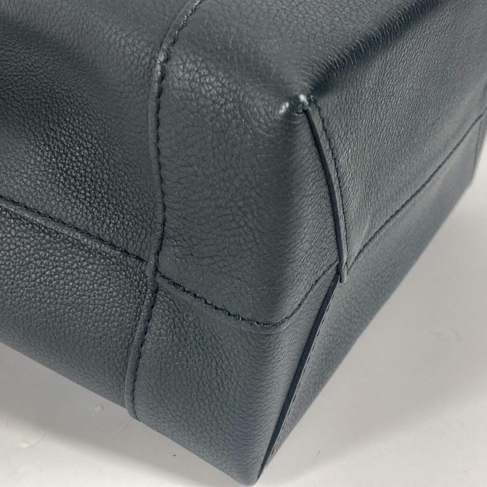 Close-up of a black leather product with stitching detail on a white background
