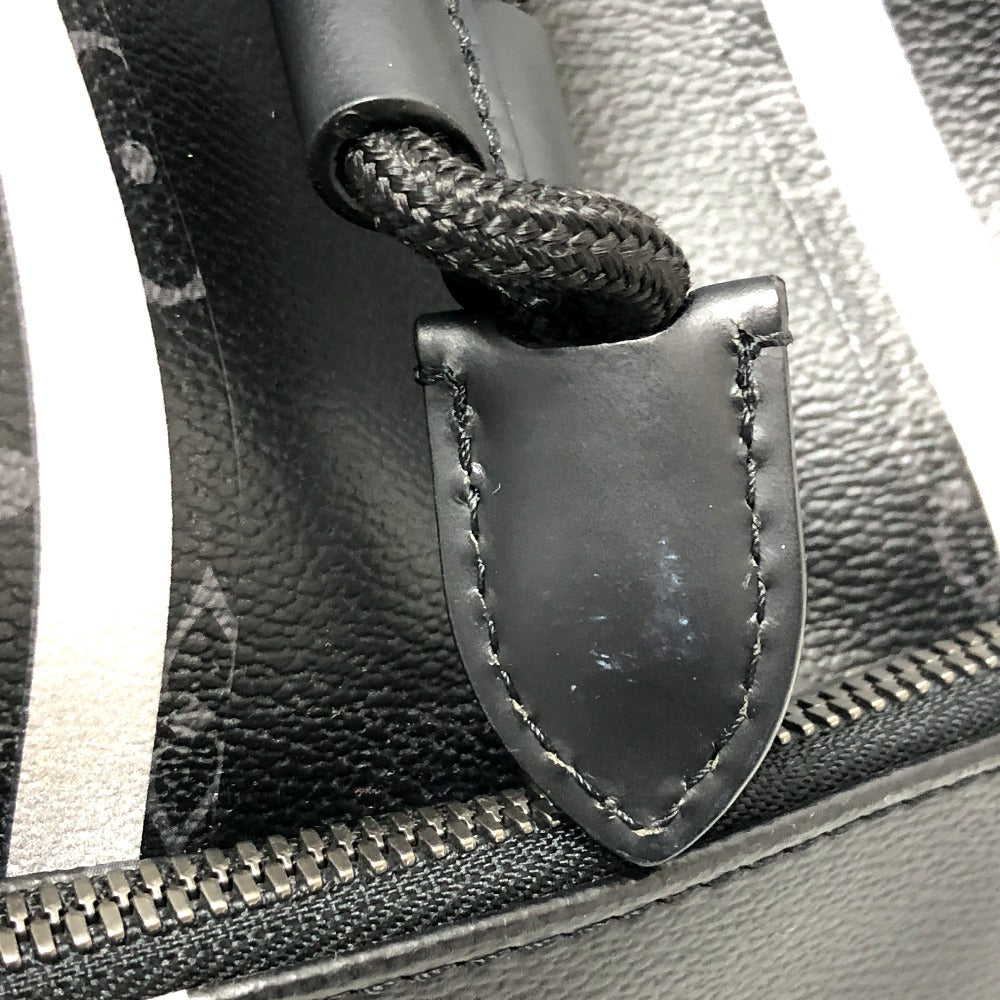 Close-up of a black leather bag with a metal clasp and zipper.