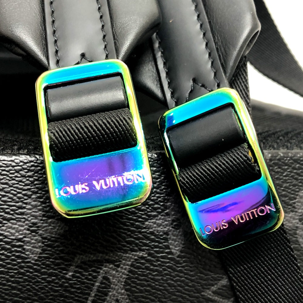 Two Louis Vuitton bag buckles with a colorful iridescent finish on a black leather background.