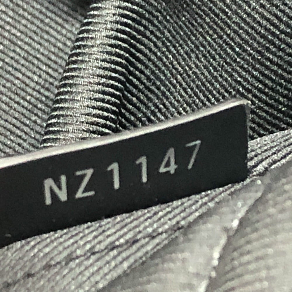 Close-up of a label with 'NZ1147' on a textured fabric background