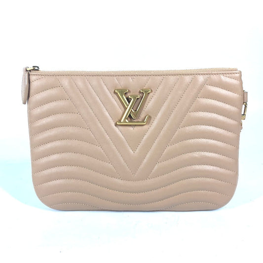 Beige handbag with a gold logo on a light blue background
